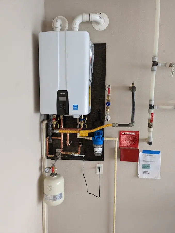 Professional plumber installing copper piping in a Pelican Marsh home